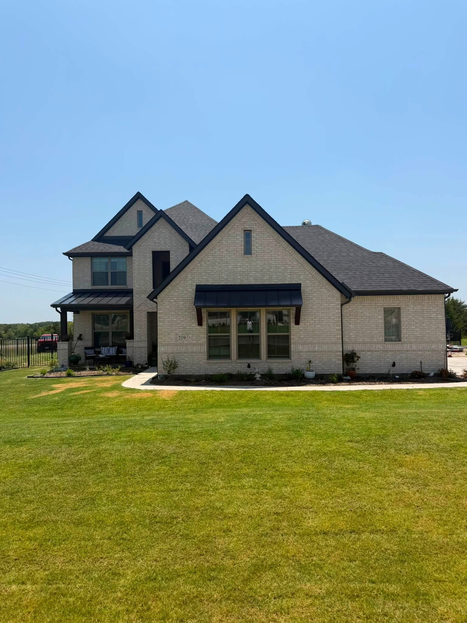 Completed residential roof on brick home