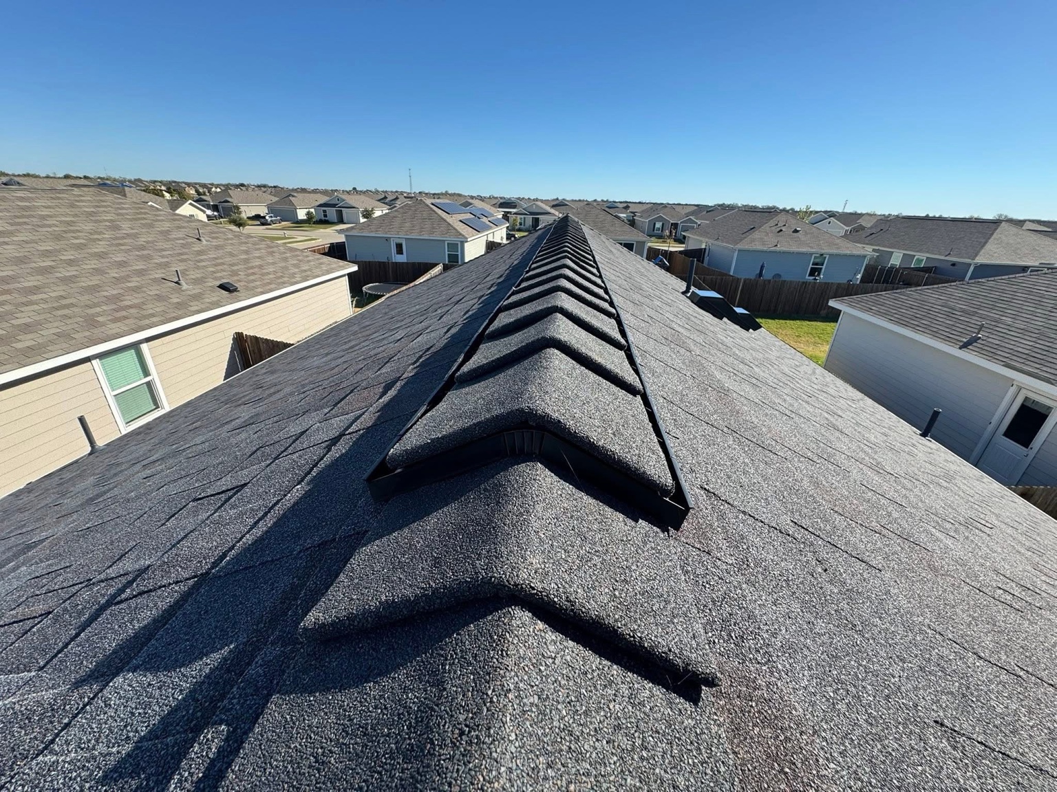 Close view of high profile ridge detail on dark roof